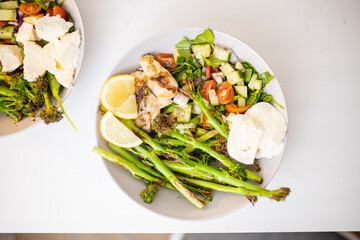 Asparagus and chicken dishes with tomato and zucchini slices