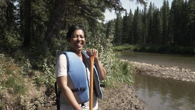 Slow Motion Of Woman Wearing Lifejacket With Canoe Oar