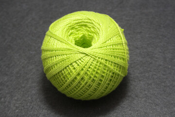 Ball of yarn on gray background.