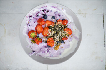 Bowl of berries and yogurt with seeds on top