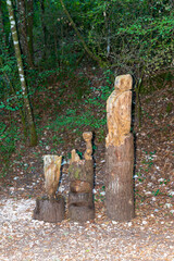 totem in inlaid wood positioned in the woods