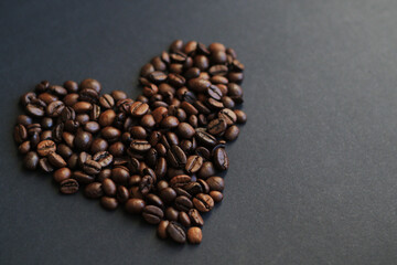 roasted coffee beans heart on black background