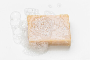 Soap bar and foam on white background, top view. Mockup for design