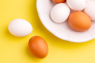 Eggs on yellow background, food concept photo
