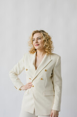 Portrait of a beautiful young woman in a white suit.