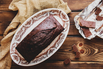 Wet chocolate cake with chocolate icing. Chocolate fudge. Homemade baking. Chocolate cake on wooden...
