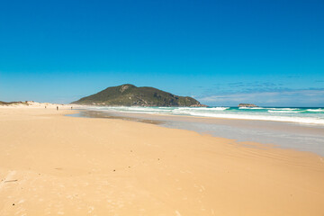 Fototapeta na wymiar Sunny day at the tropical beach in southern Brazil, Florianópolis island, Santinho beach, Florianopolis, Santa Catarina