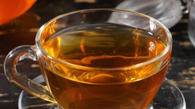 Cup of hot tea on table, closeup