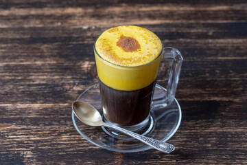 Traditional vietnamese egg coffee made of raw egg yolk and condensed milk, close up