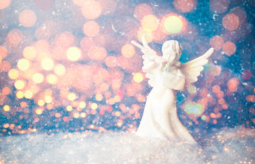 Christmas Angel Figurine and Blur Christmas Lights stock photo