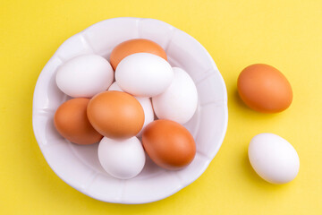 Eggs on yellow background, food concept photo
