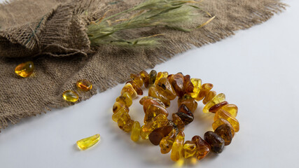 Dazzling sparkling   vintage bracelets made of yellow and green Baltic amber,  and  natural old brown linen cloth as decoration.