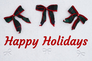 Happy Holidays message with red and green tartan Christmas bows