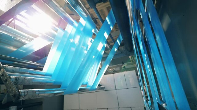 Spinning machine with blue polyethylene rolling through it
