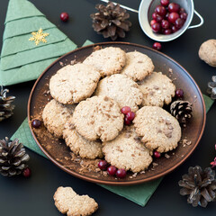 Homemade oatmeal cookies with chocolate chips and cranberries on a round ceramic dish. Selective focus.