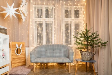 New Year's interior. The room is decorated for Christmas or New Year celebrations. A wonderful winter photo hall or photo studio. Comfortable sofas to relax
