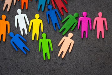 Equality and diversity concept. Multi-colored wooden figurines on a blackboard.