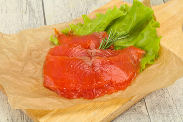 Sliced salmon fillet served rosemary