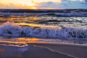 Sunset by the sea. The concept of admiring the sea against the backdrop of the setting sun.