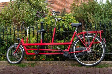 Fototapeta na wymiar Red tandem parked on a street in Edam, Holland