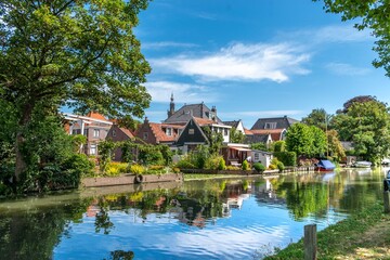 Fototapeta na wymiar Reflection of houses in the river in Edam, Holland