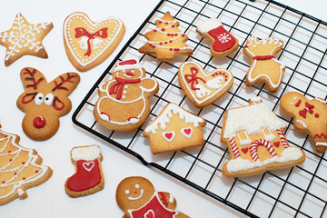 Gingerbread traditional gingerbread Christmas. Beautifully decorated with red and white glaze. Sweet dessert. Concept of celebration of festive holidays.