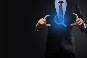 Businessman, man hold in hand magnifying glass icon.business, technology and internet concept