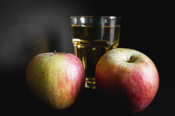 Organic apples with an apple juice in the background