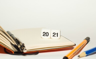 2021 written with cubes with notebook and pencil, illustration