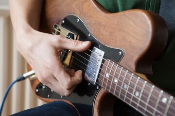 Man Strums Chord On Guitar