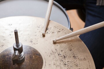 Obraz na płótnie Canvas Drumsticks On Metal Cymbal