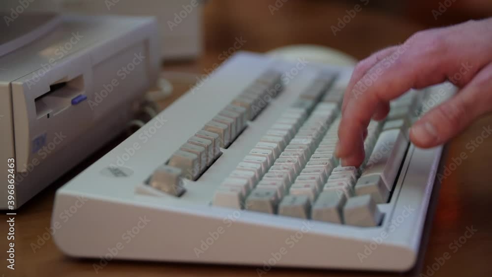Poster close-up of man typing on retro keyboard. media. man uses old computer, typing on old keyboard. old 