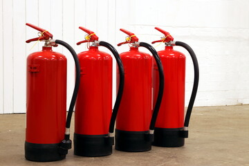 Obraz premium Fire extinguishers lined up for use.