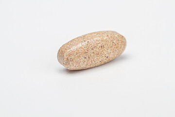 Fototapeta na wymiar Brown tablet natural supplement