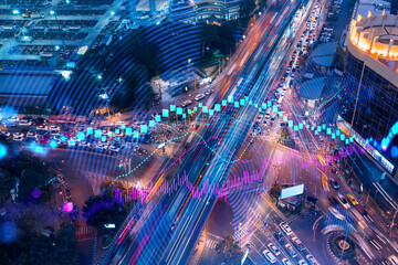 Fototapeta na wymiar FOREX and stock market chart hologram on aerial view of road, busy urban traffic highway at night. Junction network of transportation infrastructure. The concept of international trading.