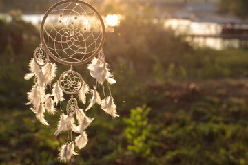 Beautiful handmade dream catcher outdoors. Space for text