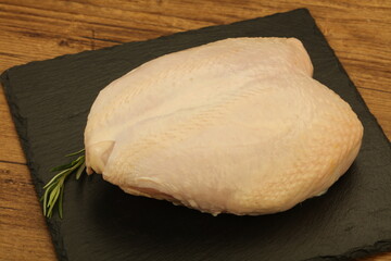 Raw whole chicken breast with skin
