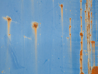 Old metallic blue wall with rust