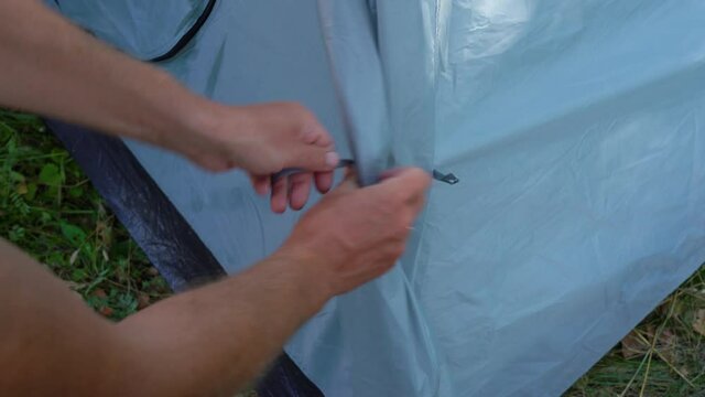 Closeup view 4k video of male hands and details of camping tent.