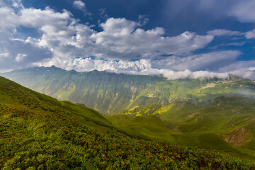 Fototapeta na wymiar Beautiful mountain landscape at Caucasus mountains with clouds and blue sky