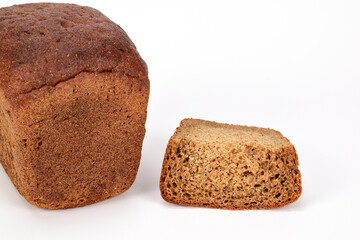 A loaf of homemade black bread next to a cut slice isolated on a white background.