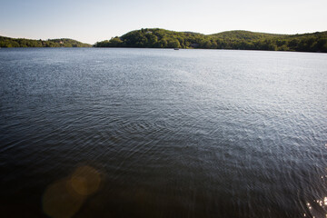 Calm lake with mountains in background