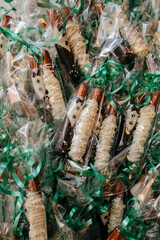 Bride and Groom pretzel favors in saran wrap with green ribbon