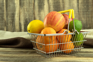 Tangerines and oranges, grapefruit and lime, apple and avocado on a dark background
