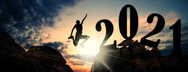 banner of man jumping on cliffs to 2021 new year