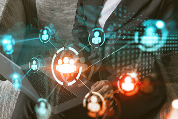 Multi exposure of woman works on computer background and people icon network hologram. Concept of social media.