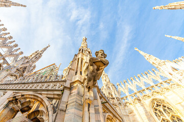 Roof of Milan Cathedral Duomo di Milano with Gothic spires and white marble statues. Top tourist...