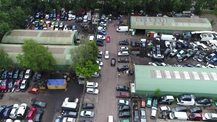Aerial bird view of wrecking yard or scrapyard junkyard is location of business in dismantling where wrecked or decommissioned vehicles are brought and usable parts are sold for operating automobiles