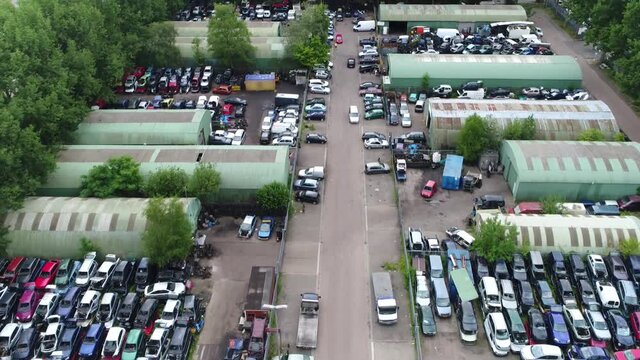 Aerial view of wrecking yard or scrapyard junkyard is location of business in dismantling where wrecked or decommissioned vehicles are brought and usable parts are sold for operating automobiles 4k