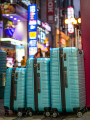 Blue suitcases on the busy Japanese street